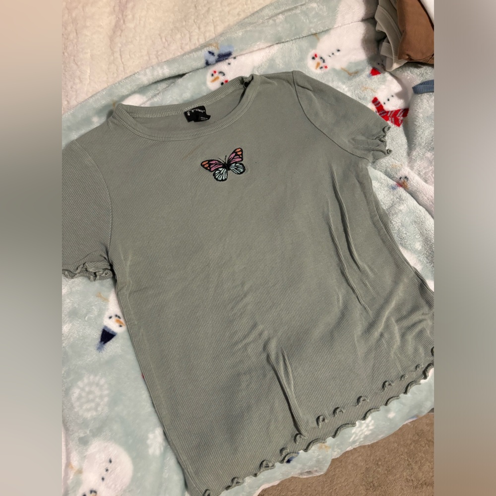 Butterfly, sage green top.